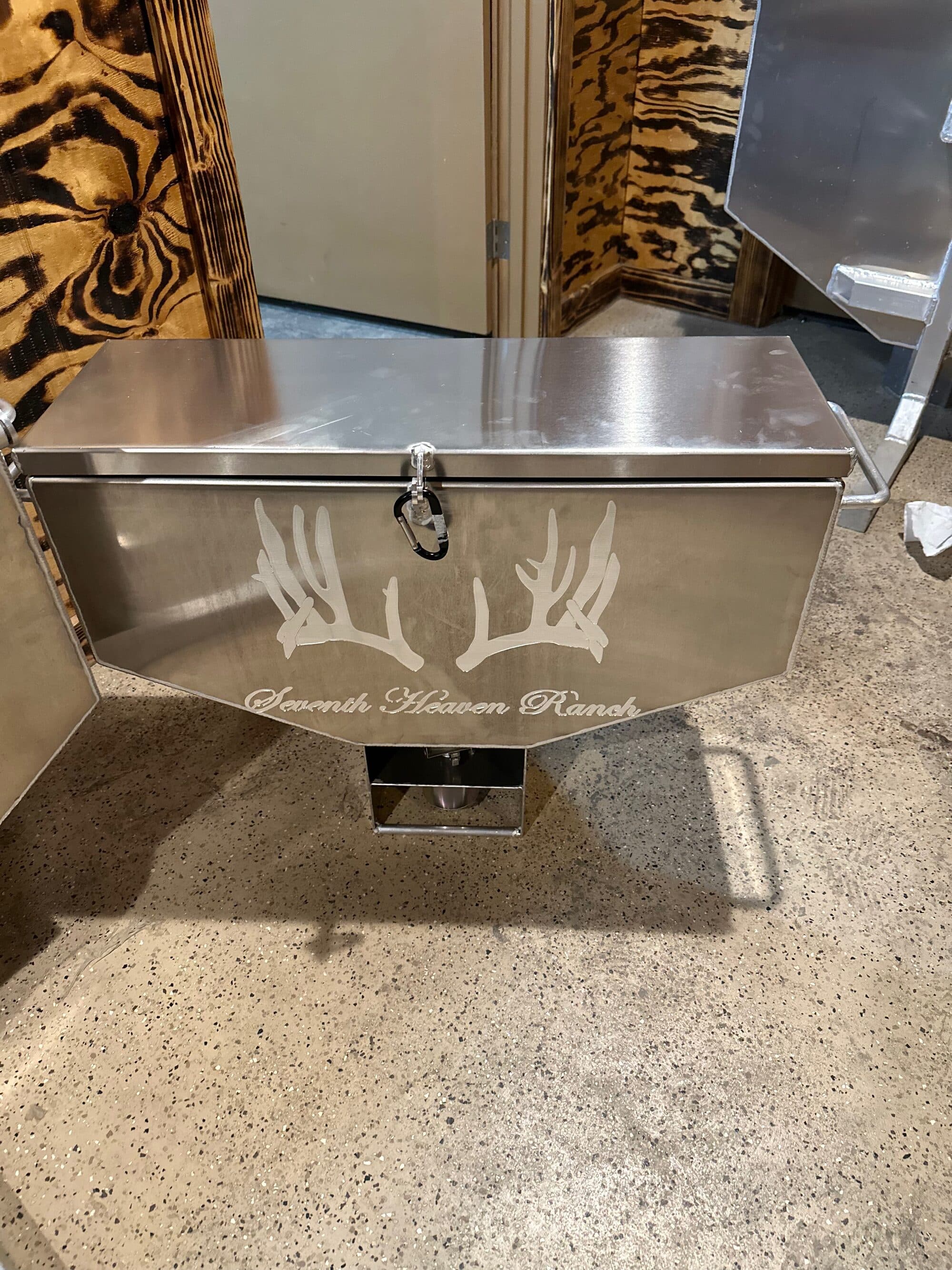 100 lb. aluminum road feeder with a customer's ranch brand laser-engraved on the face — every order is engraved with your logo.